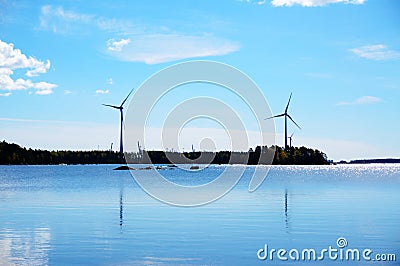 Windmills for renewable electric energy production at coast, Fin Stock Photo