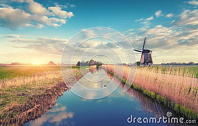 Windmills at sunrise. Rustic spring landscape Stock Photo