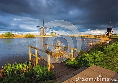 Windmills at sunset in Kinderdijk, Netherlands. Rustic landscape Editorial Stock Photo