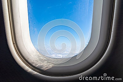 The window of the airplane. A view of porthole window on board an airbus for your travel concept or passenger air transportation Stock Photo