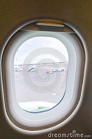 The window of the airplane. A view of porthole window on board an airbus for your travel concept or passenger air transportation Stock Photo