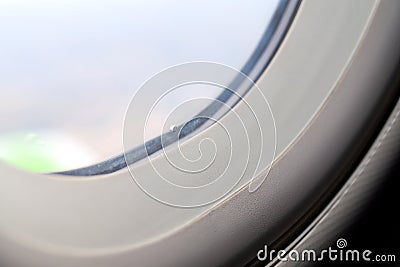 The window of the airplane. A view of porthole window on board an airbus for your travel concept or passenger air transportation Stock Photo