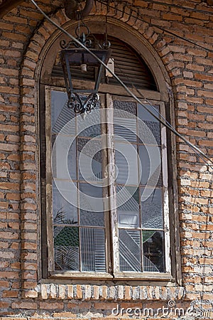 Old window and apparent brick wall Stock Photo