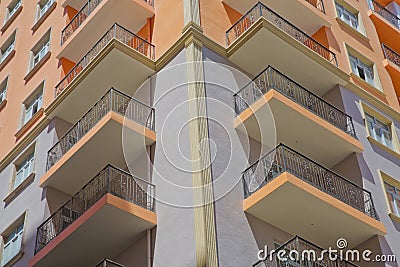 Window balcony on a stone building . elegant decorative old stone balcony. low level perspective of multi level classic white Editorial Stock Photo