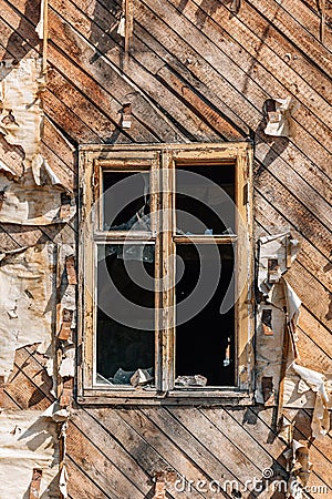 Window with broken glass in a wooden abandoned house Stock Photo