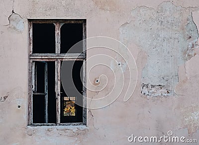 Window of a building surrounded by the cracks of the wall Stock Photo