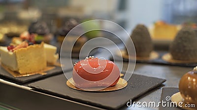 Window of cake shop with variety of cakes on display. Pastry shop with of muffins, eclaire, cakes with fruits, berries Stock Photo