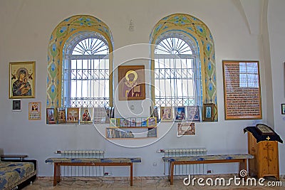 Window of a church. The interior of a small provincial church, the interior decoration. Icons, prayers. Russia Editorial Stock Photo