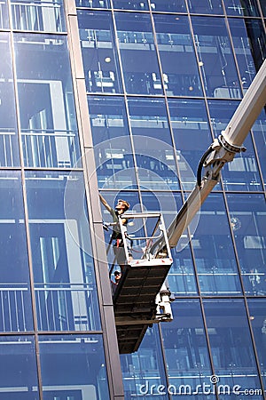 Window cleaners working on a modern high rise glass building Editorial Stock Photo