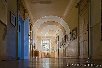Big window at the end of a hallway in deserted colonial house Stock Photo