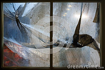 Window frame with dirty stained plastic film Stock Photo