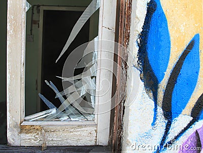 Window glass broken abandoned house wall facade flowers Stock Photo