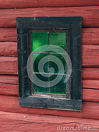 Window with green glass of an old log house at Valdresmusea Folk Stock Photo