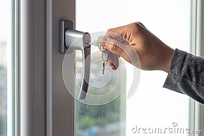 Key locking window with key for kids safety. Window Restrictors in the home. Stock Photo