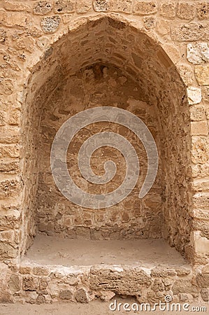 Window like ancient structure carved into the interior wall of ancient Bahrain Fort Stock Photo