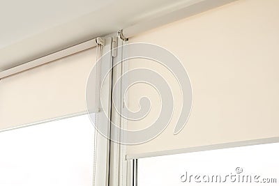 Window with modern roll blinds in room Stock Photo