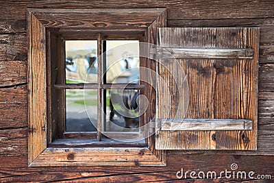 Window with open wooden shutter in an old rural building Stock Photo