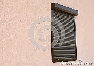 Window with rolling shutter and copy space. Window with rolling shutter for house protection. Stock Photo