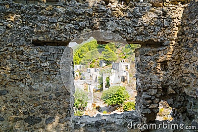 Window in the stone wall overlooking the ghost town Kayakoy. Mugla - Turkey Stock Photo