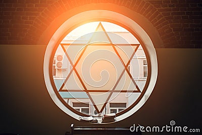 Window in synagogue in form of Star of David, six-pointed star with sunlight, Jewish symbol Stock Photo
