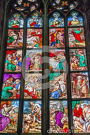 Window view with colorful glass depicting biblical scenes at magnificent Cathedral of Milano, Milan, Italy Editorial Stock Photo