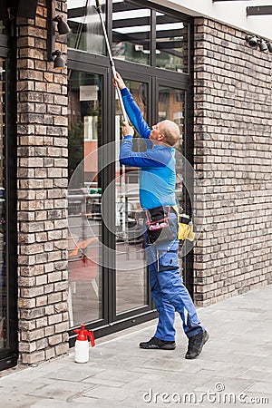 Window washer working at building outdoor Stock Photo