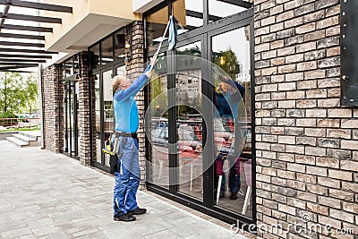 Window washer working at building outdoor Stock Photo