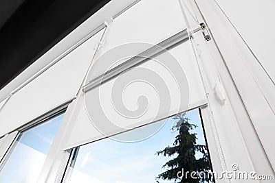 Window with white roller blinds indoors, low angle view Stock Photo