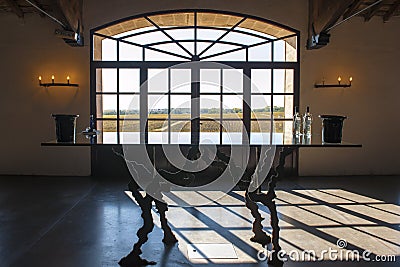 Window in Wine Cellar Bordeaux with view to vineyards.. Shadow of window on floor. Stock Photo