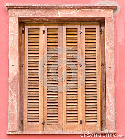 Window with wooden louver shutters Stock Photo