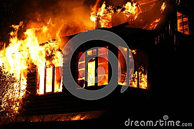 Windows of the burning house Stock Photo