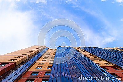 Windows of a high multi-storey residential building. Residential apartment building. Blue sky. Place under the text. . An article Editorial Stock Photo