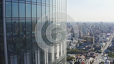 Windows of high-rise building on background city. Stock footage. Top view of panoramic Windows of skyscraper on Stock Photo