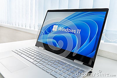 Windows 11 logo on laptop screen. A new operating system update from Microsoft Editorial Stock Photo