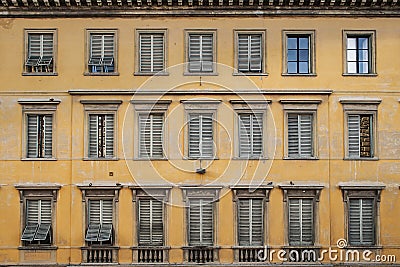 Windows on old yellow vintage building Stock Photo