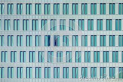 Windows pattern on cyan modern skyscraper or glazed office facade conveys concept of shared office space or corporate headquarter Stock Photo