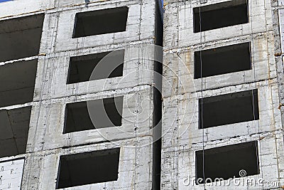 Windows of a residential multi-apartment high-rise building under construction under sunlight. Real estate construction Stock Photo