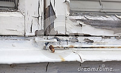 Windowsill where the color is flaking and the wood cracked Stock Photo