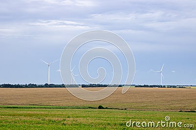 Windpower and agriculture. Wind turbines for electricity generation. Stock Photo