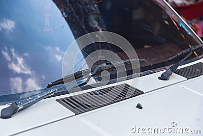 A windscreen wiper or windshield wiper is a device used to remove rain, snow, ice and debris from a windscreen or windshield Stock Photo