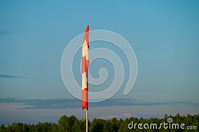 Windsock at the airfield during calm weather Stock Photo