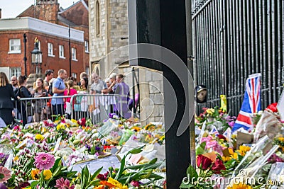 WINDSOR, ENGLAND- 11 September 2022: Mourners at Windsor Castle with flowers following`s death Editorial Stock Photo