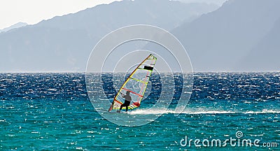 Windsurfer on the background of high mountains rides on the waves of the Red Sea in Egypt Dahab South Sinai Editorial Stock Photo