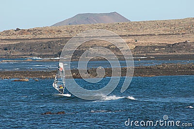 Windsurfer sailing in the coast of Fuerteventura. Editorial Stock Photo