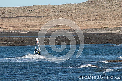 Windsurfer sailing in the coast of Fuerteventura. Editorial Stock Photo