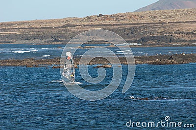 Windsurfer sailing in the coast of Fuerteventura. Editorial Stock Photo