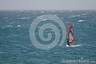 Windsurfer sailing in the sea. Editorial Stock Photo