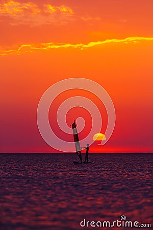 Windsurfer silhouette against sun Stock Photo