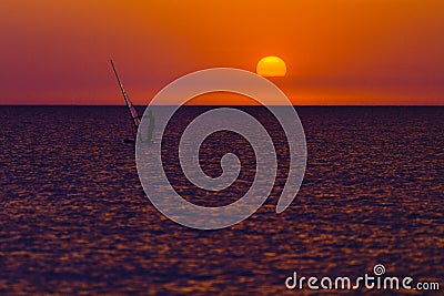 Windsurfer silhouette against sun Stock Photo