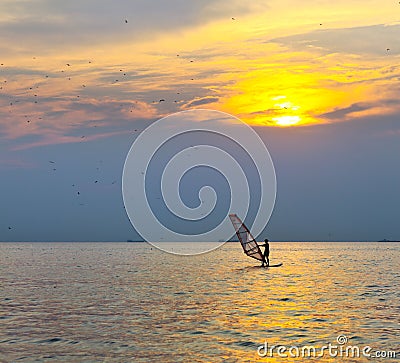 Windsurfer silhouette over sea sunset Stock Photo